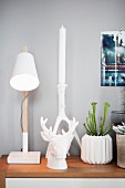 Scandinavian-style still-life arrangement of table lamp and white accessories