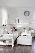 White corner couch, matching ottoman and shabby-chic side table in corner of living room