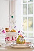Tag with welcome message tied to pear on place setting