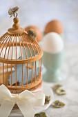 A bird cage as Easter decoration on a breakfast table
