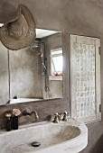Stone sink in grey limewashed bathroom