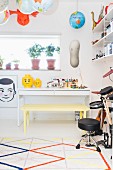 Desk, toys and musical instruments in teenager's bedroom