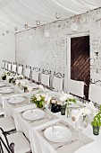 White wedding dinner table set in rustic style