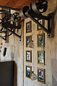 Gallery of framed vintage photos below renovated mechanical element on concrete wall