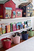 Shelves and colourful buckets organising various items in child's bedroom