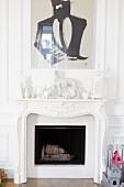 White figurines and painting above fireplace