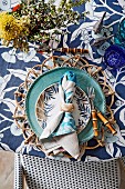 Shades of blue and various floral patterns on a laid table with a maritime flair