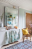 Vintage-style mirror and wicker chair in Bohemian kitchen