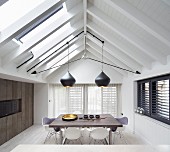 Dining room with exposed roof structure and beams