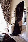 Dark velvet curtain in arched doorway