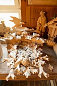 Elaborate cuckoo clock and other carvings on workbench