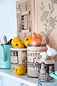 Glass jars covered in vintage-style printed paper and used for storage