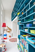 Blue partition shelving in cheerful, colourful child's bedroom