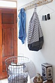 Bag made from striped fabric and old denim hung from coat rack
