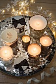 Sparkling silver arrangement of tealight holders and fairy lights on tray