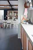 View from kitchen into dining room with continuous concrete floor