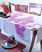 Tablecloth printed with pink dragon on Oriental-style dining table