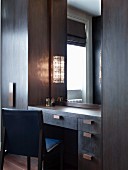 Dressing table integrated in dark wooden wardrobes