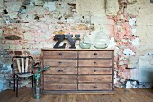Vintage chest of drawers against rustic stone wall