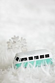 Miniature VW bus amongst pile of white fluffy rug