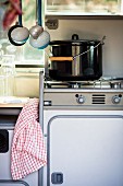 Saucepan on gas cooker in camper van