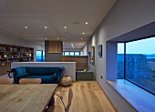 Open-plan designer interior of architect-designed house with panoramic window with sea view