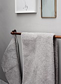 Copper piping used as towel rail mounted on wall