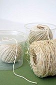 Reels of string in clear plastic pots