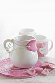 White milk jug with hand-made pink felt drip catcher and coaster
