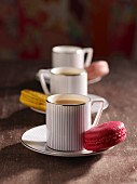 Tea in striped cups with macaroons