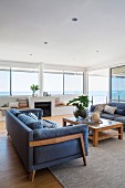 Elegant living area with upholstered furniture, built-in benches and sea view