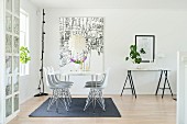 Delicate dining table, classic chairs and large picture in dining area
