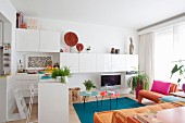 White furniture and colourful home textiles in small living room