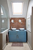 Battered blue washstand in niche under sloping ceiling