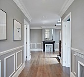 Elegant hallway with mouldings on walls and panelled doors