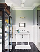 Two-tone wall and cabinet with glass doors in vintage-style bathroom