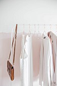 Women's clothing on white clothes rail