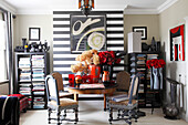 Flowers on dining table in front of black-and-white striped wall