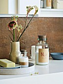 Bathroom accessories arranged on a washstand with flowers