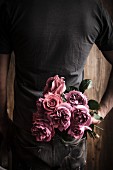 Man holding bouquet of roses for Valentine's Day