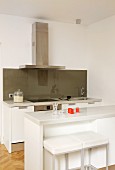 Breakfast bar and bar stools in white designer kitchen