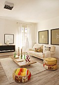 Cream flokati rug, low coffee table and colourful ethnic pouffes in comfortable living area