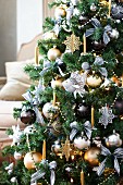 Christmas tree decorated with ornamental fish and metallic baubles