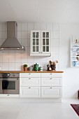 White country-house kitchen with white floor and wall-mounted cabinet