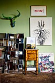 Collection of artworks on light green wall