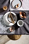Table set in shades of grey with crockery of various types