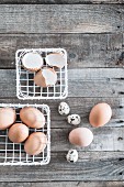 Hens' and quails' eggs in white metal baskets