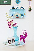 Collection of kitschy ornaments in pale blue and magenta