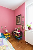 Kitschy eclectic bedroom with pink walls