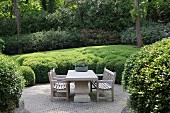 Seating area on terrace surrounded by bushes